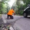 Anggota BPBD Kabupaten Cirebon Fauzan mengecek keretakan di Jalan Pelangon Desa Babakan Kecamatan Sumber